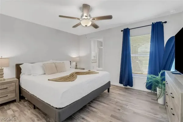 a bedroom with a bed and a chandelier