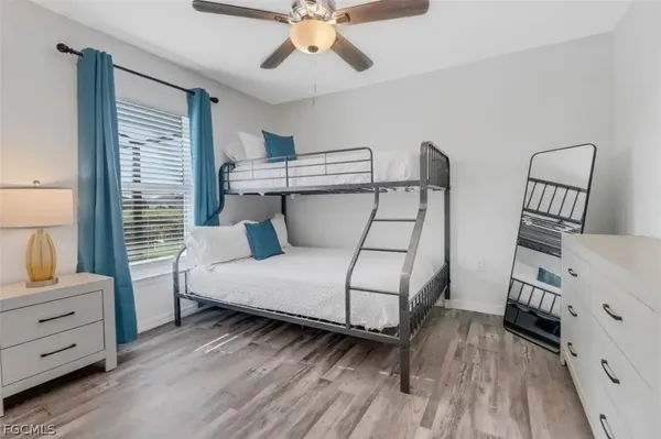 a bedroom with a bed and a dresser in it