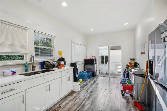 a kitchen with stainless steel appliances a sink stove and cabinets
