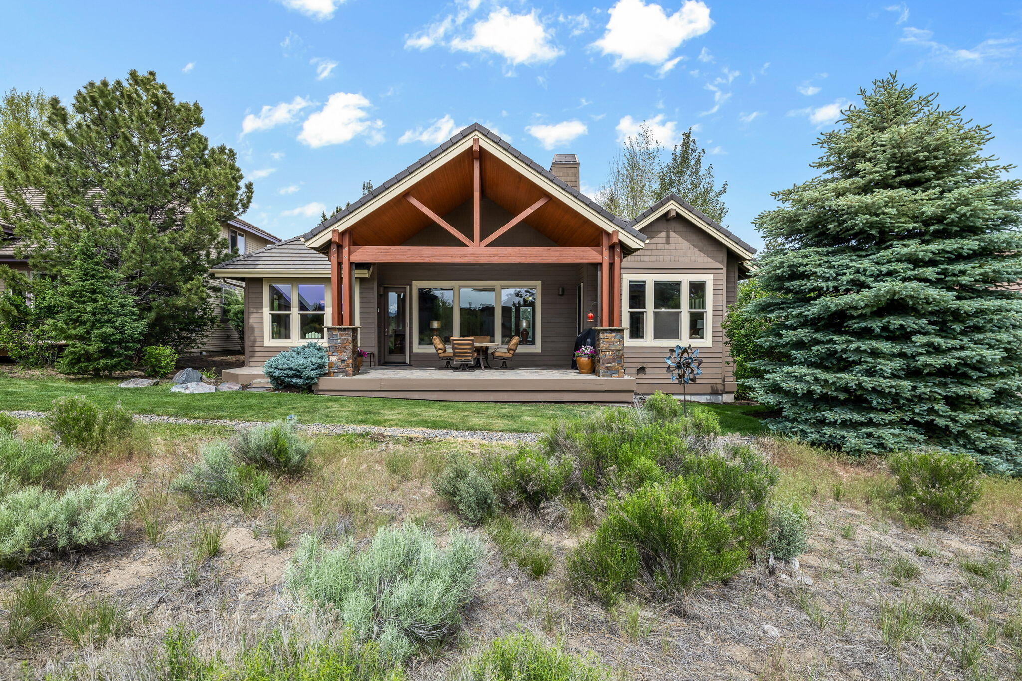 61879 Fall Creek Loop Bend, OR 97702 - Photo 28 of 29 Expansive paver patio is equipped with remote controlled blinds for those glorious sunny Central Oregon days.