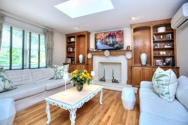 a living room with furniture fireplace and flat screen tv