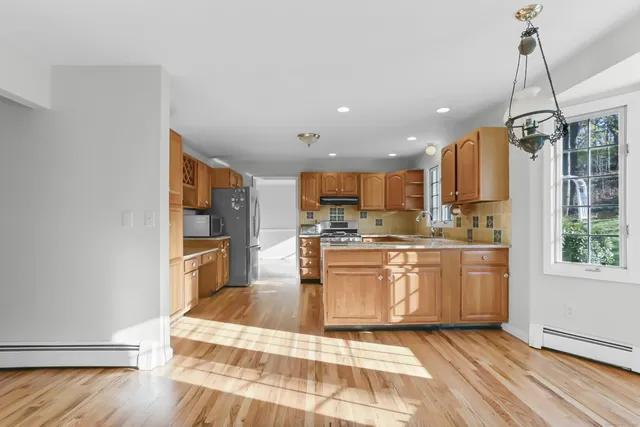 a bedroom with a bed and a flat tv screen on dresser