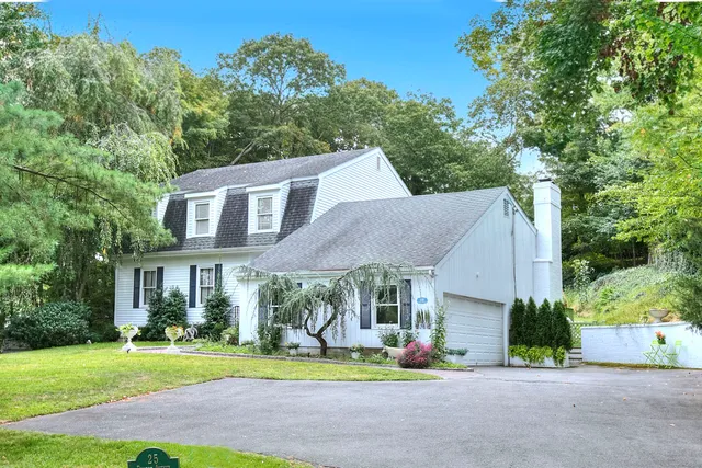 a front view of a house with a yard table and chairs