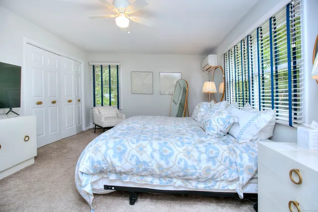 a bedroom with furniture and a window