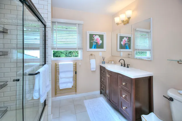 a bathroom with a sink vanity granite tub and shower