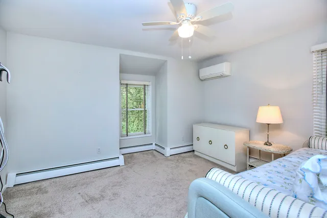 a bedroom with furniture and a window