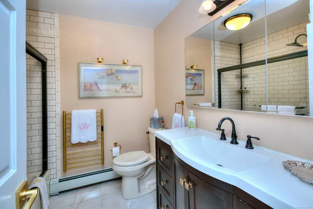 a bathroom with a toilet sink and mirror