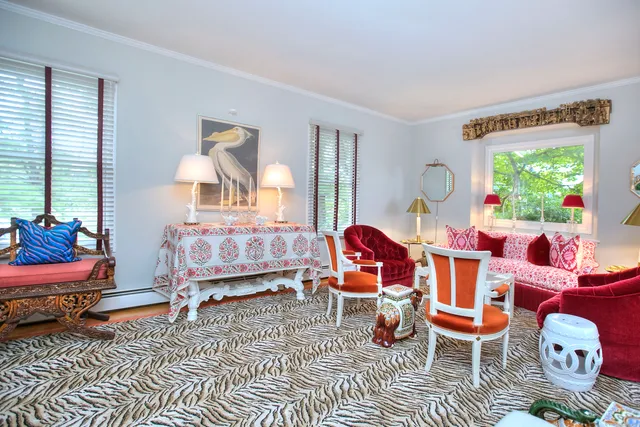 a living room with furniture a rug and a lamp