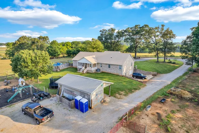 a view of a house with backyard and sitting area