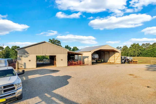 an aerial view of residential houses with outdoor space and lake view