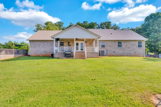 a front view of a house with yard and green space