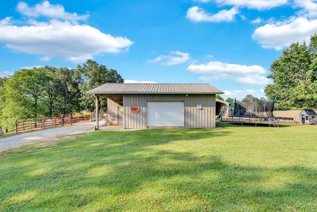 a front view of a house with a garden and trees