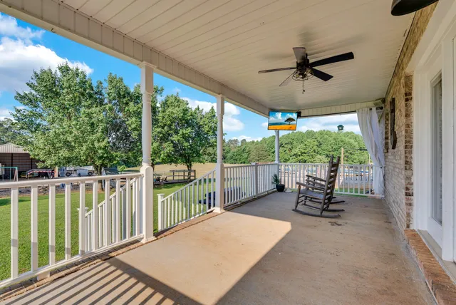 a balcony with furniture and a yard