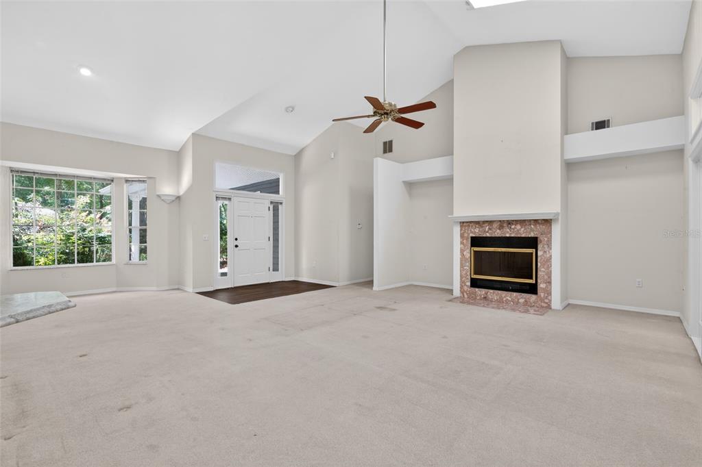 9626 Southwest 53rd Road Gainesville, FL 32608 - Photo 7 of 23 a view of an empty room with a fireplace and a window