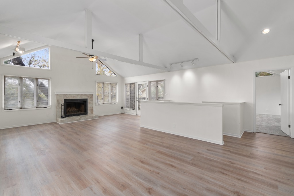 2109 Bridle Path, Unit B Austin, TX 78703 - Photo 1 of 1 an empty room with wooden floor and fireplace