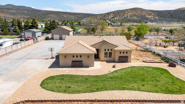 7776 Wagon Road East St. George, UT 84770 - Photo 64 of 76 View of front of house with a mountain view and stucco siding