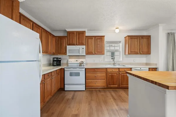 a living room with furniture and a kitchen view