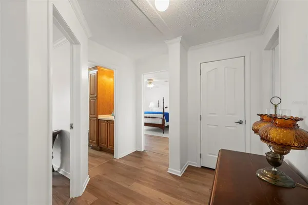 a bedroom with a large bed wooden floor and window