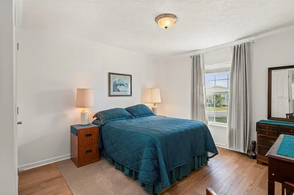 a bedroom with a bed a table and chair