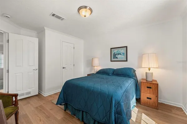 a bedroom with a bed and a chandelier