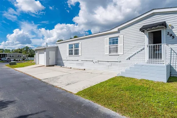 a view of house with yard in front of it