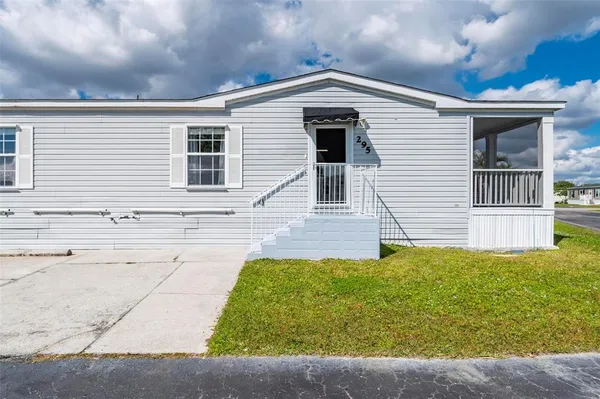 an aerial view of a house with a big yard