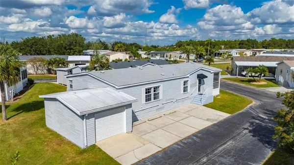 a view of a house with a swimming pool and a yard