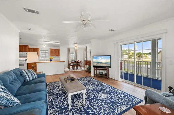a balcony with wooden floor table and chairs