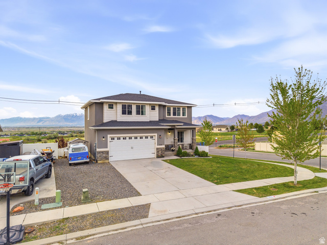 256 West Horizon Loop Payson, UT 84651 - Photo 27 of 33 View of front of home featuring a mountain view, covered porch, concrete driveway, and stone siding