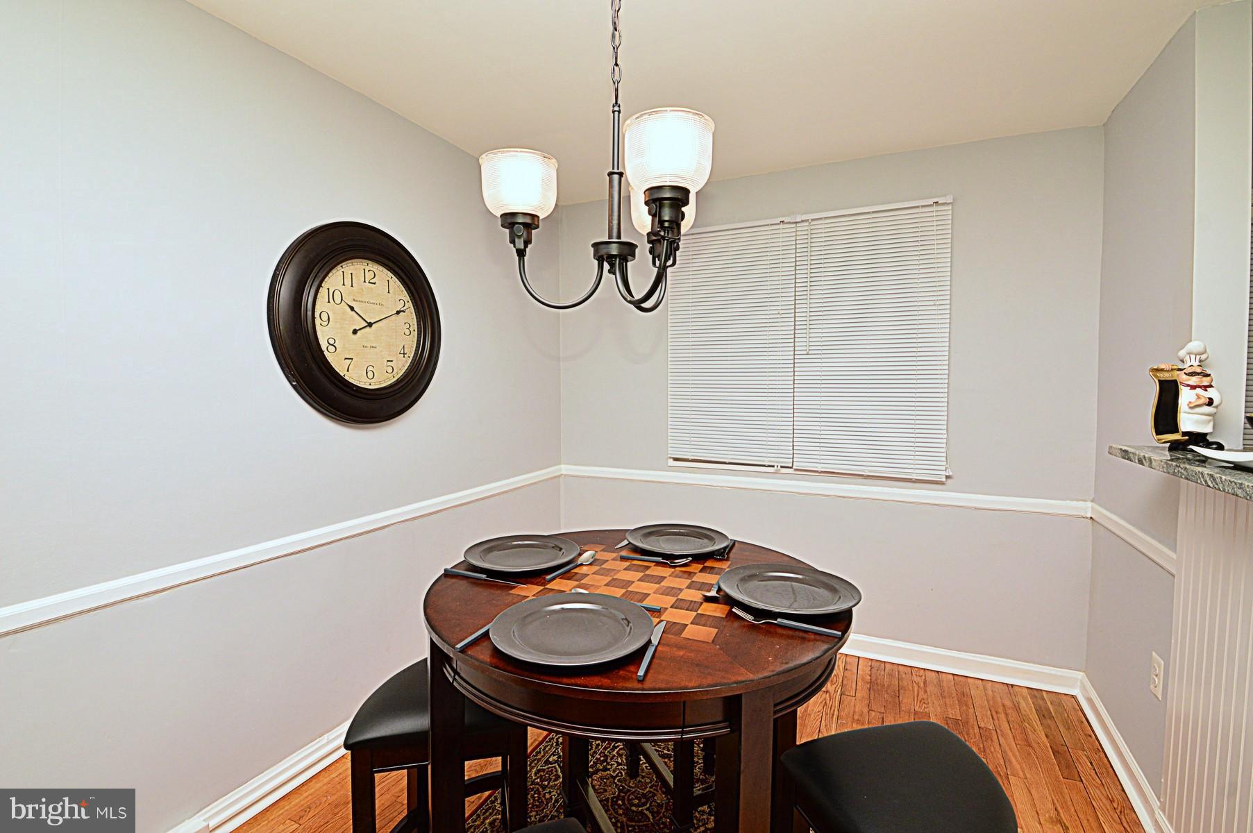 1105 Wedgewood Road Baltimore, MD 21229 - Photo 13 of 30 a view of a dining room with a table and chairs