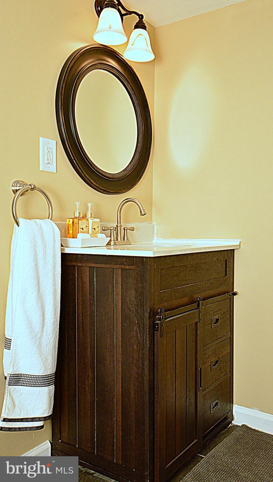 1105 Wedgewood Road Baltimore, MD 21229 - Photo 21 of 30 a bathroom with a sink and a mirror