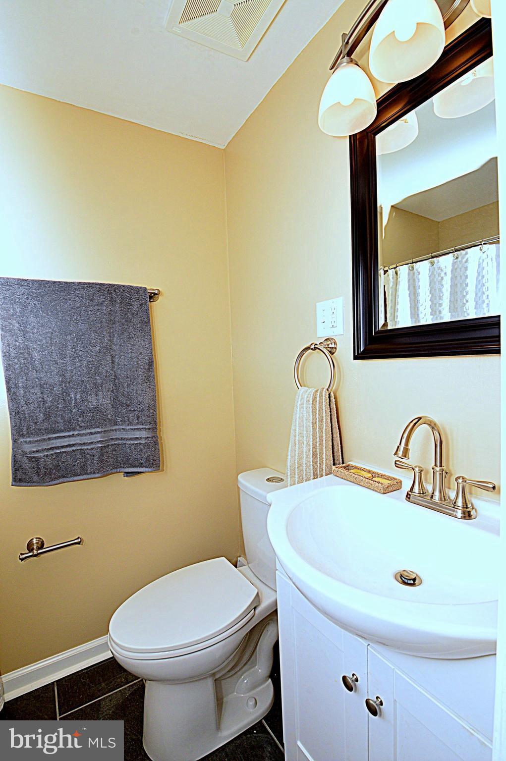 1105 Wedgewood Road Baltimore, MD 21229 - Photo 27 of 30 a bathroom with a toilet sink and mirror