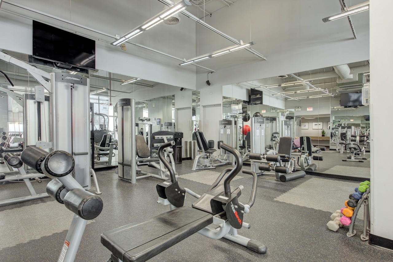 655 West Irving Park Road, Unit 1903 Chicago, IL 60613 - Photo 16 of 22 a view of a room with gym equipment