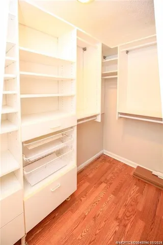 a view of a room with wooden floor and cabinet