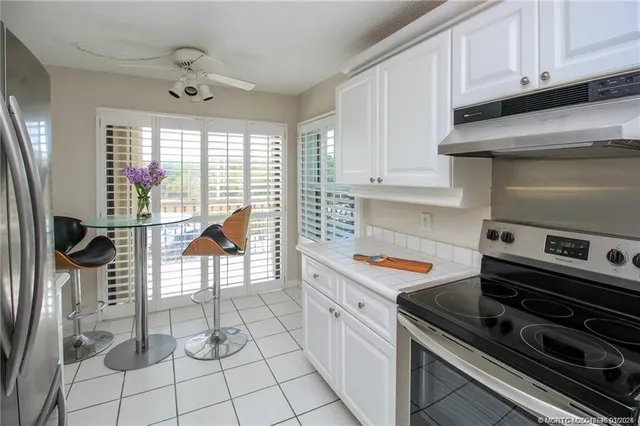 a kitchen with granite countertop a stove and a sink