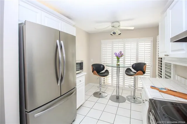 a kitchen with stainless steel appliances a refrigerator and a stove