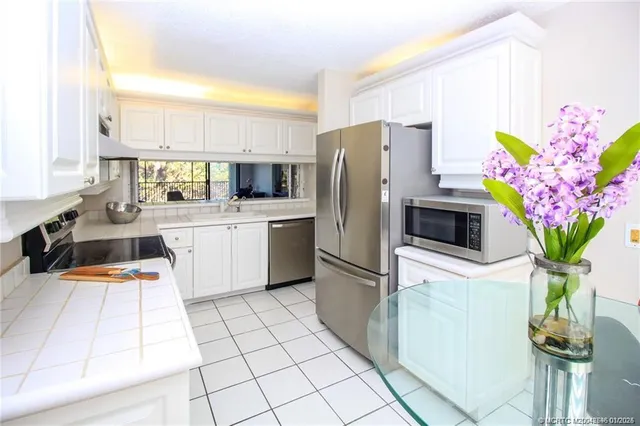 a kitchen with stainless steel appliances a sink cabinets and a counter top space