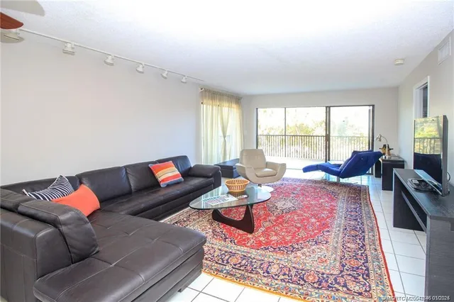 a living room with furniture rug and window