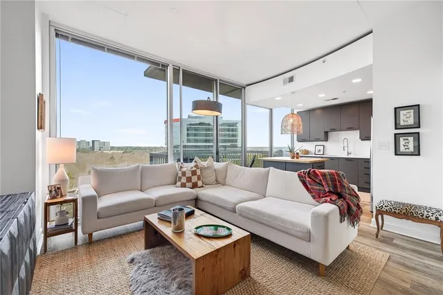 a living room with furniture and large windows