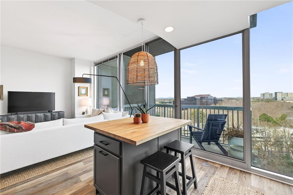 3300 Windy Ridge Parkway Southeast, Unit 1019 Atlanta, GA 30339 - Photo 2 of 37 a living room with furniture and a flat screen tv