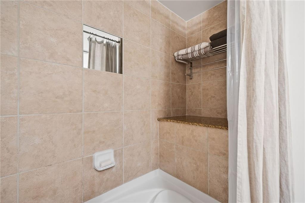 3300 Windy Ridge Parkway Southeast, Unit 1019 Atlanta, GA 30339 - Photo 21 of 37 a bathroom with a shower