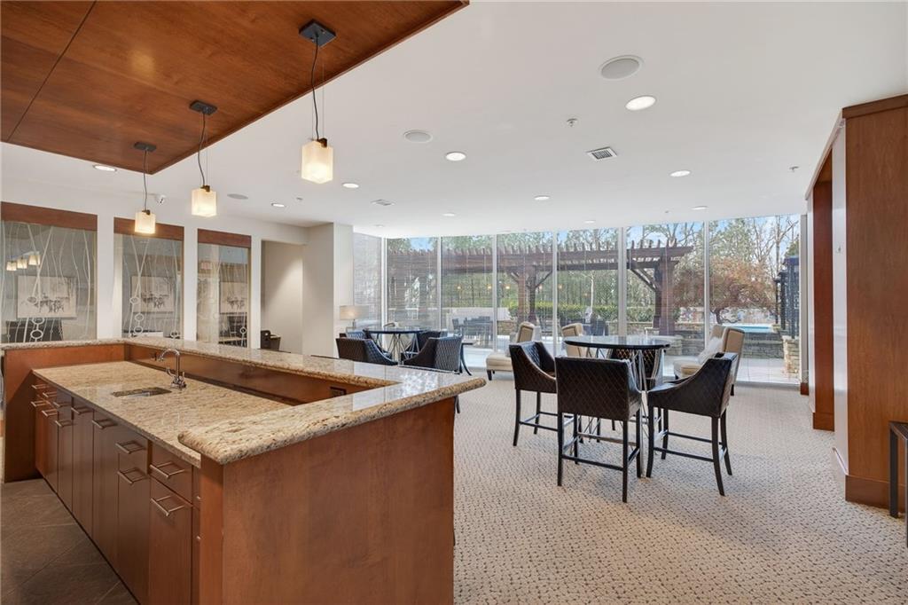 3300 Windy Ridge Parkway Southeast, Unit 1019 Atlanta, GA 30339 - Photo 25 of 37 a dining hall with stainless steel appliances granite countertop a sink and a large window