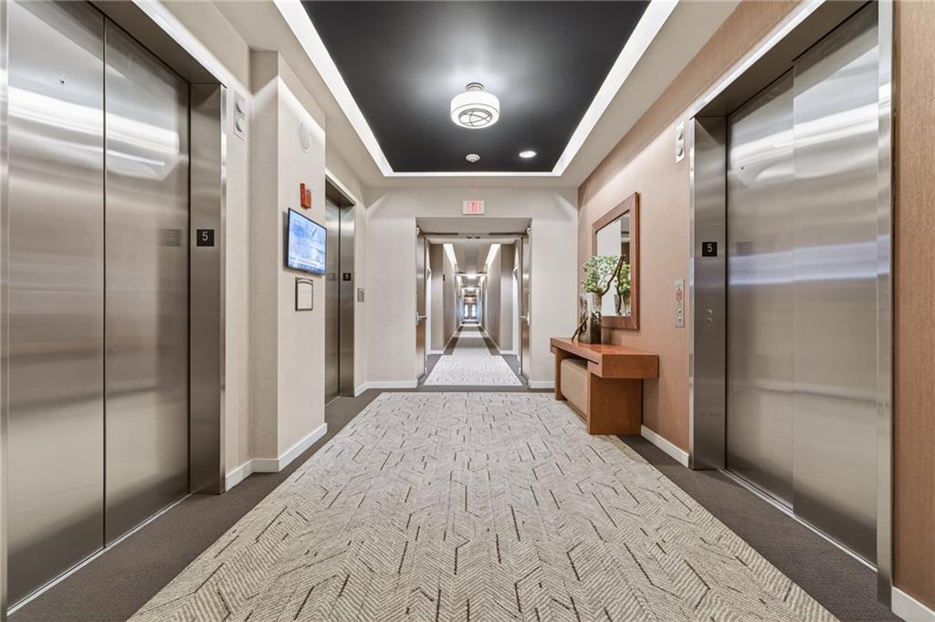 3300 Windy Ridge Parkway Southeast, Unit 1019 Atlanta, GA 30339 - Photo 32 of 37 a view of a hallway with wooden floor and a bathroom