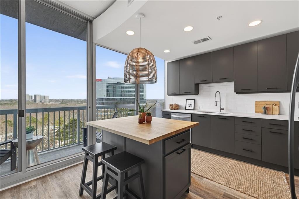 3300 Windy Ridge Parkway Southeast, Unit 1019 Atlanta, GA 30339 - Photo 5 of 37 a kitchen with a sink window and cabinets