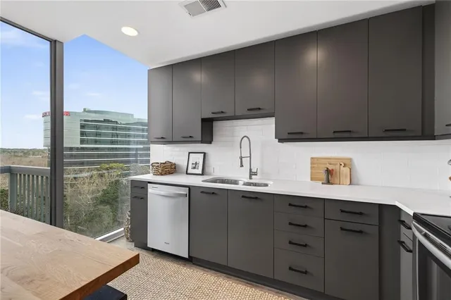 a kitchen with a sink a stove and cabinets