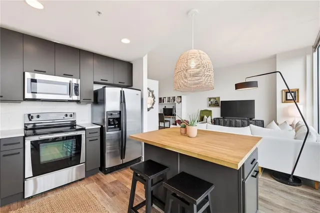 a kitchen with a table chairs refrigerator and microwave