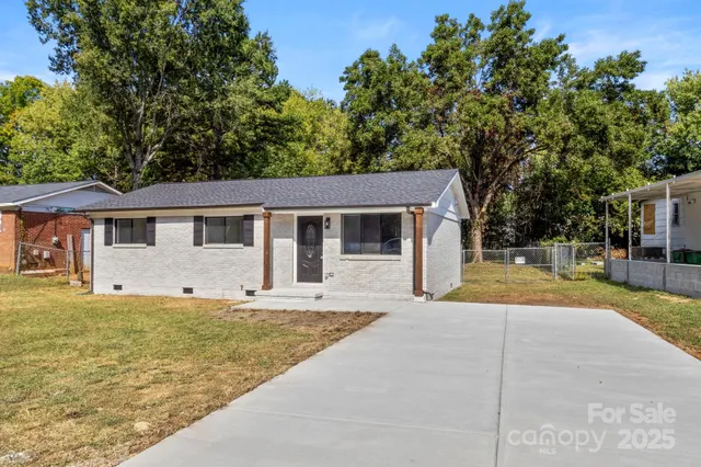 a view of a house with pool and a yard