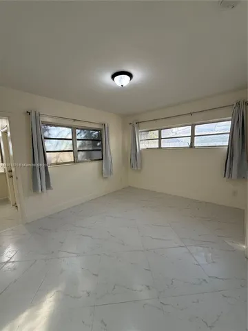 a view of an empty room with windows