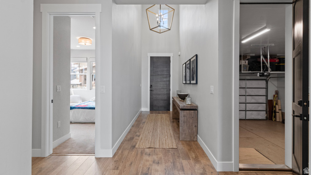 355 East Overlook Loop Hideout, UT 84036 - Photo 23 of 40 Entry hallway looking towards the front door. Wood-finish flooring, a contemporary geometric chandelier, and tall ceilings