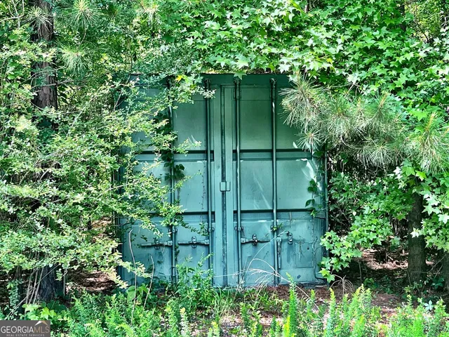 a view of backyard with swimming pool